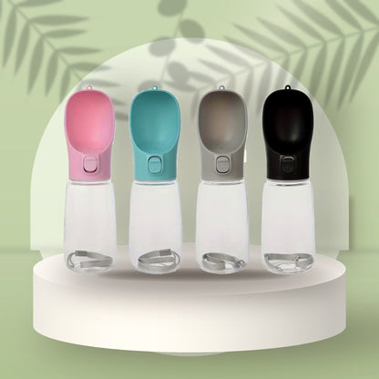 Portable Pet Water Bottle in pink, teal, grey and black on a sage podium