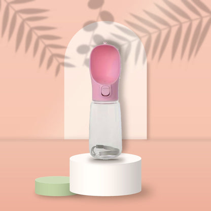 Pink Portable Pet Water Bottle on a peach podium
