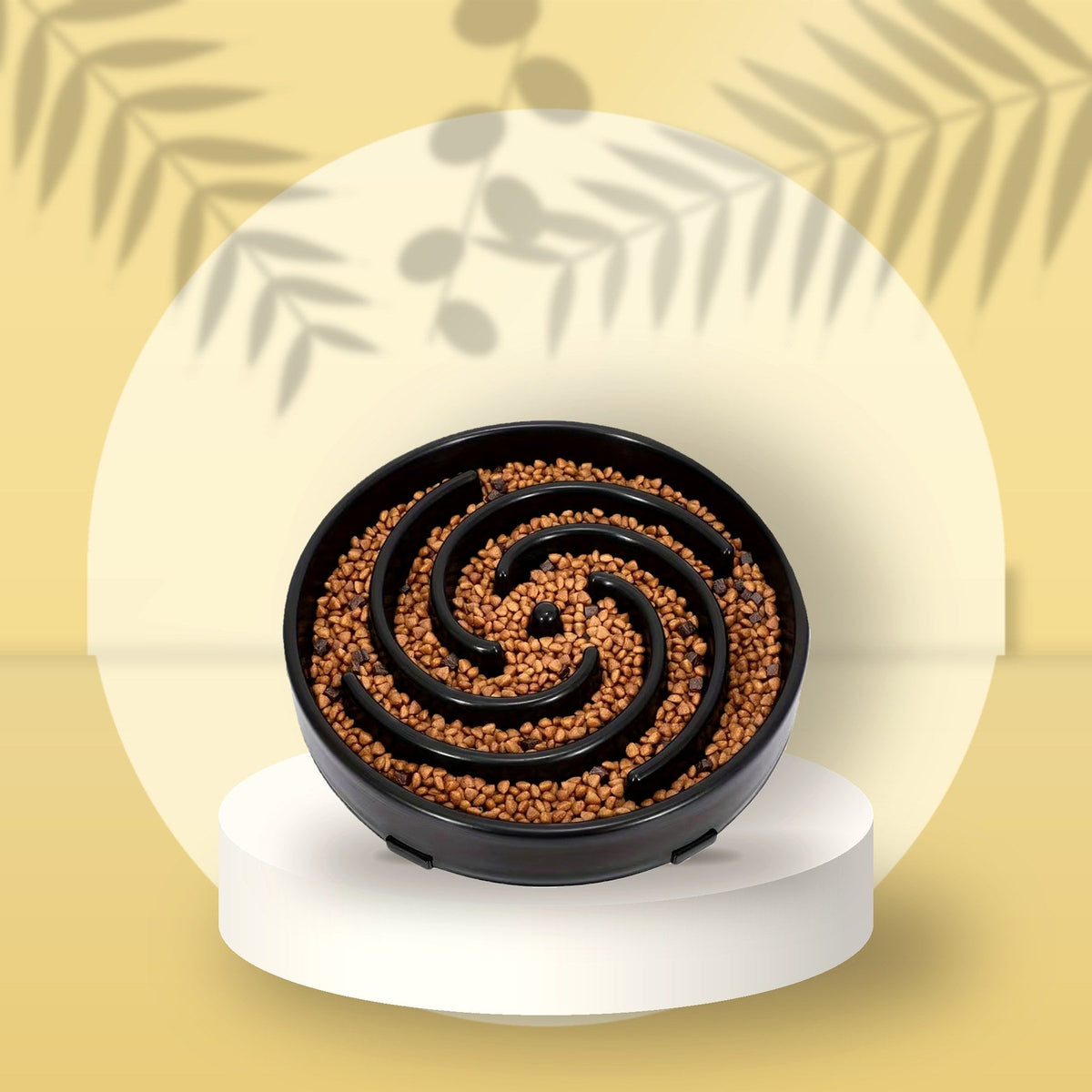 Black Spiral Slow Feeder Bowl on a butter-yellow podium